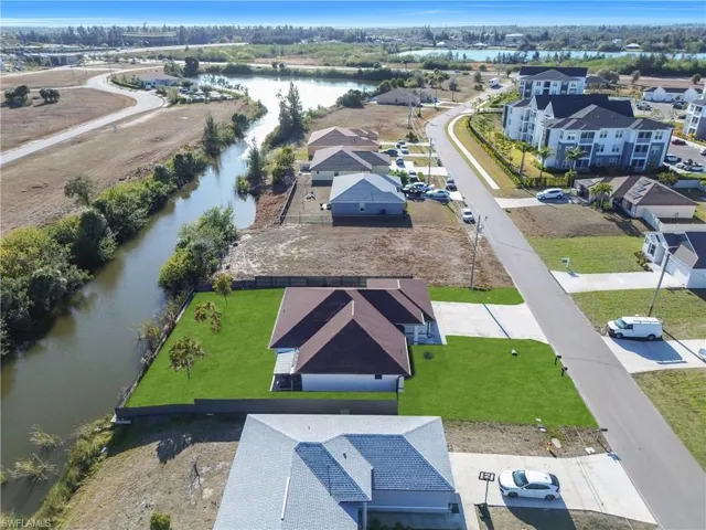 Aerial perspective of suburban area featuring a large body of water