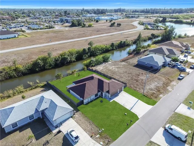 Aerial perspective of suburban area featuring a large body of water