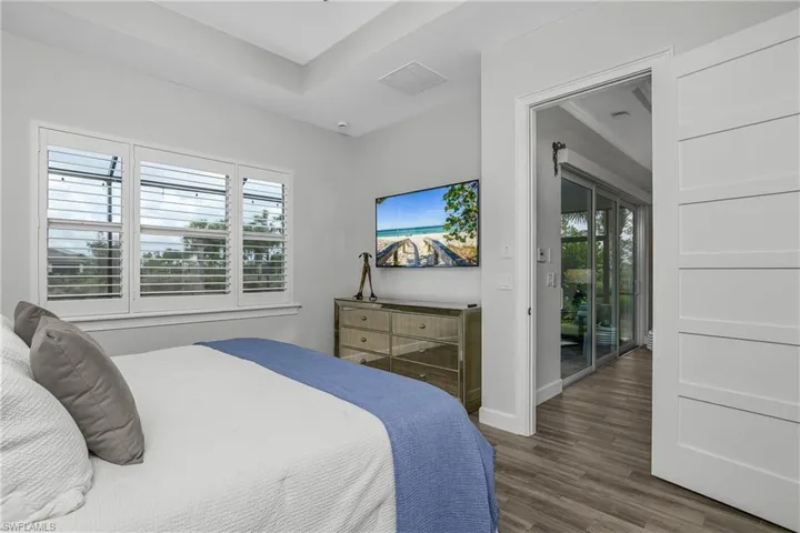 Owner's Bedroom with volume ceilings, large windows with Plantation Shutters, 8' Shaker Style Doors