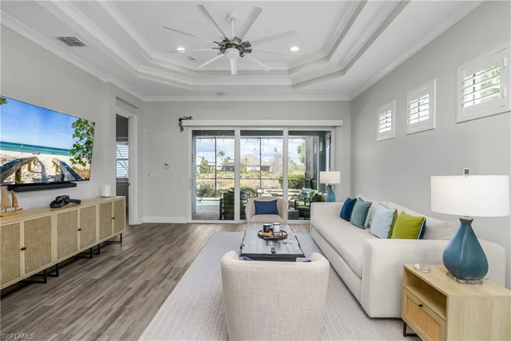 Great room featuring ceiling fan, Tile floors, ornamental molding, and recessed lighting, Plantation Shutters