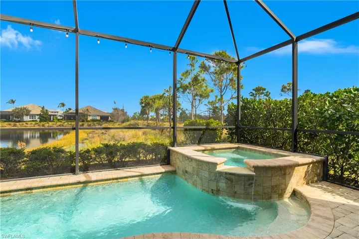 Relaxing pool / spa with a lanai and a sunroom