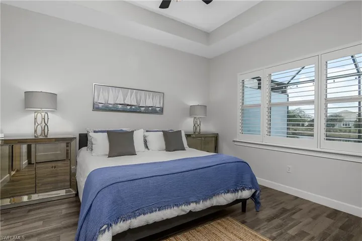 Owner's Suite featuring Tile Plank-wood-style flooring and ceiling fan. Plantation Shutters.