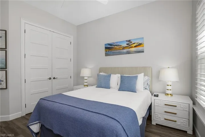 Guest Bedroom featuring Plank Tile flooring, a closet, multiple windows, and ceiling fan. Note the 8 foot Shaker Style Doors.
