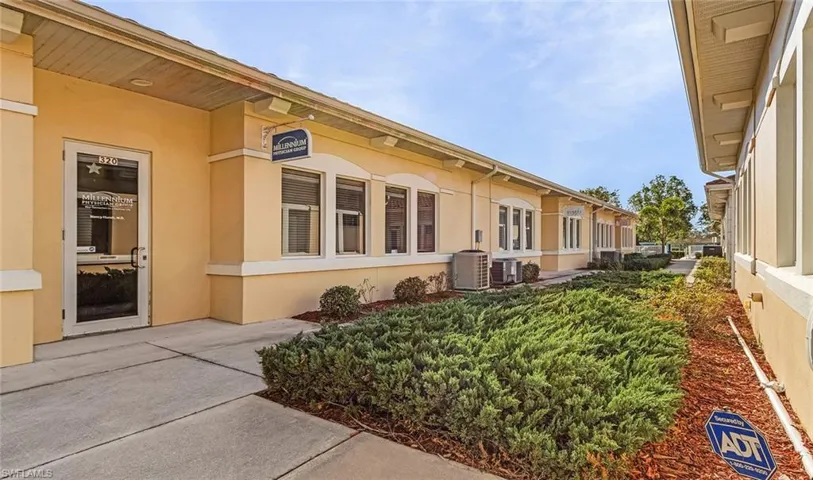 View of Office exterior featuring central air condition unit and stucco siding