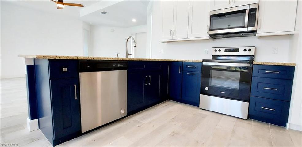 2 tone Wood cabinets with stainless steel applicances