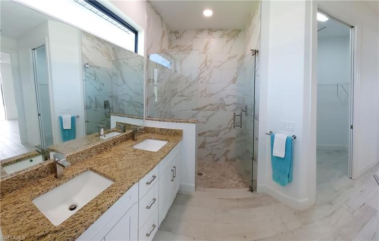 The master bathroom includes a shower, double sink.
