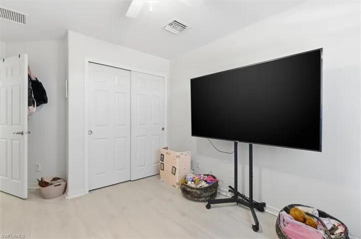 Game room featuring light wood-style flooring and a ceiling fan