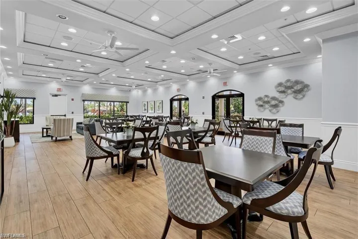 Dining area with coffered ceiling, a healthy amount of sunlight, ceiling fan, and ornamental molding