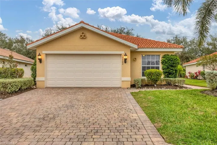 View of front of house featuring a garage and a front yard