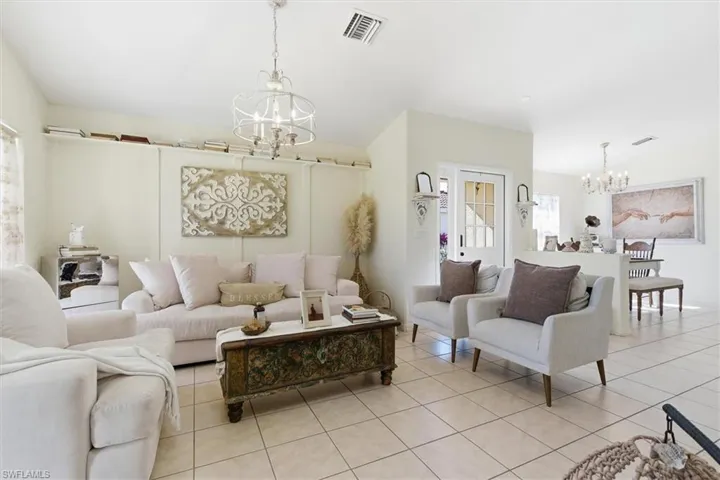 Living room with a chandelier and light tile patterned flooring