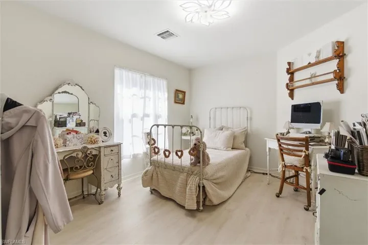 Bedroom with an office area and light wood-type flooring