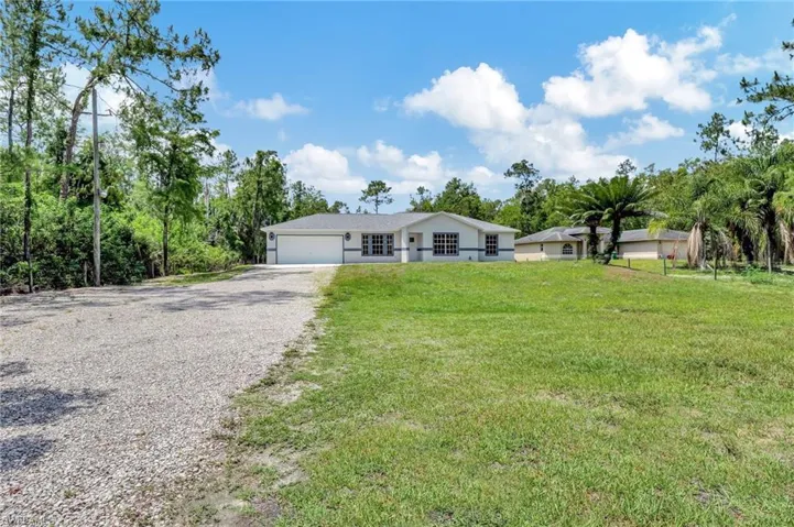 Home is set back with a nice long driveway and front gate
