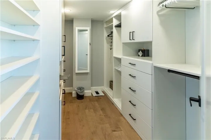 Walk in closet featuring light wood-style flooring