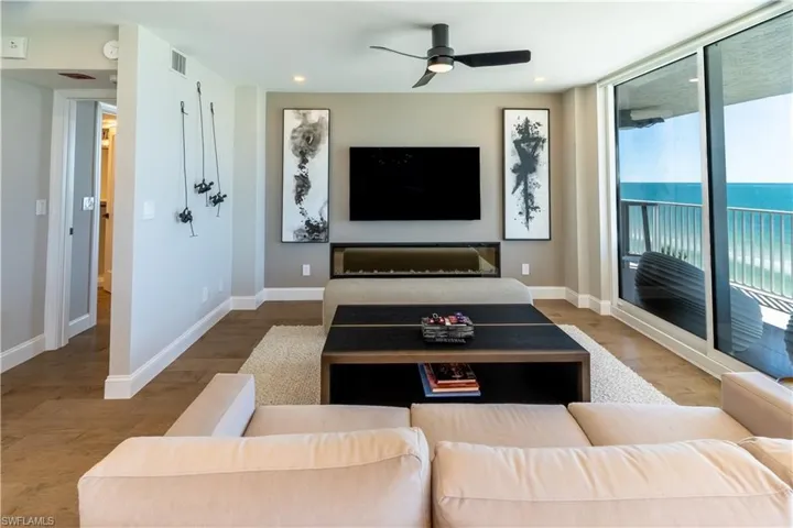 Living room featuring wood finished floors, a ceiling fan, and recessed lighting
