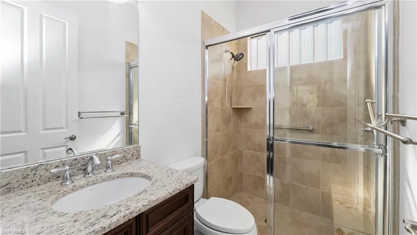 Full bathroom featuring a stall shower and vanity