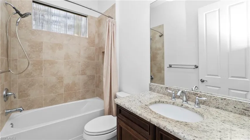 Bathroom featuring shower / bath combo and vanity