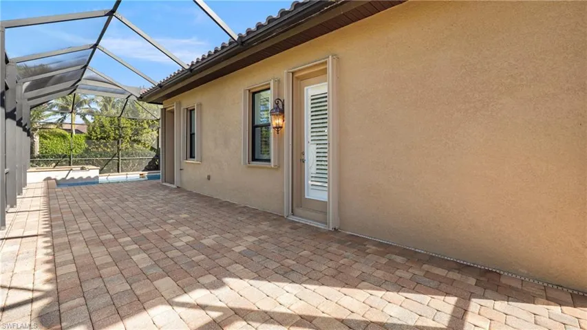 View of patio featuring a sunroom and glass enclosure