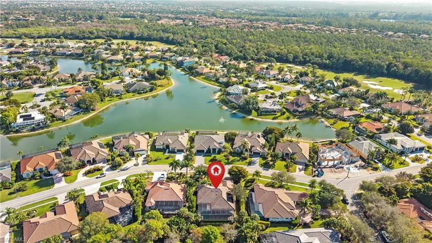 Aerial view of property and surrounding area with a nearby body of water and nearby suburban area