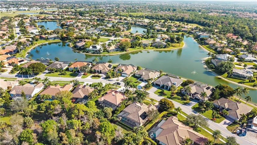 Aerial view of property's location with a nearby body of water and nearby suburban area