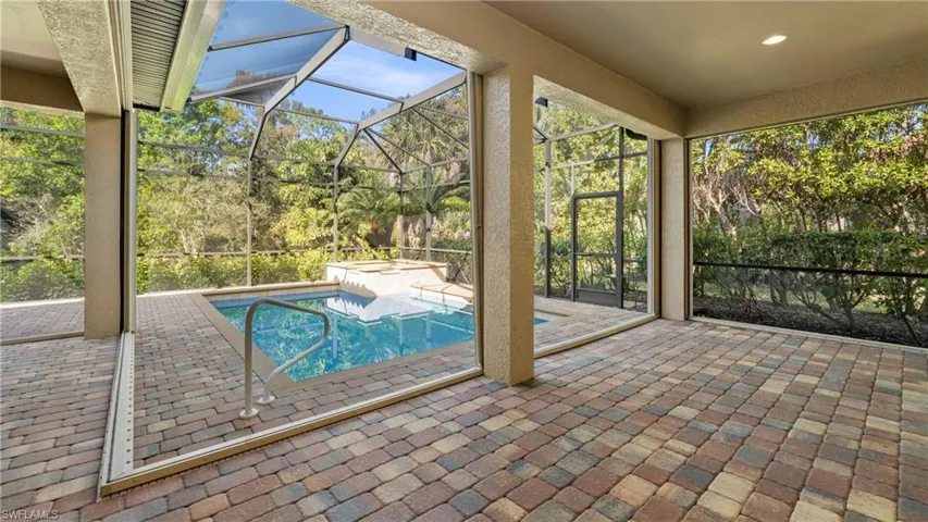 Relaxing pool / spa with a lanai, a patio, and a sunroom