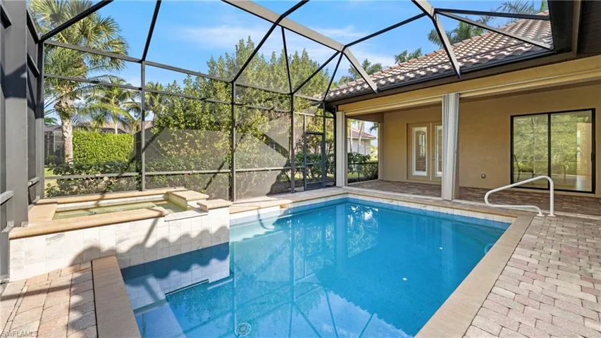 Outdoor pool with a sunroom, a patio, a lanai, and a hot tub
