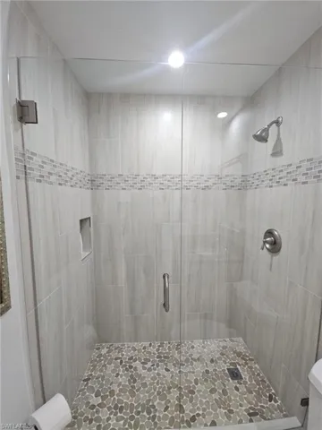 Full bathroom with a shower stall