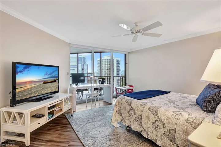 Main Bedroom with Ceramic tile flooring and sliders to lanai