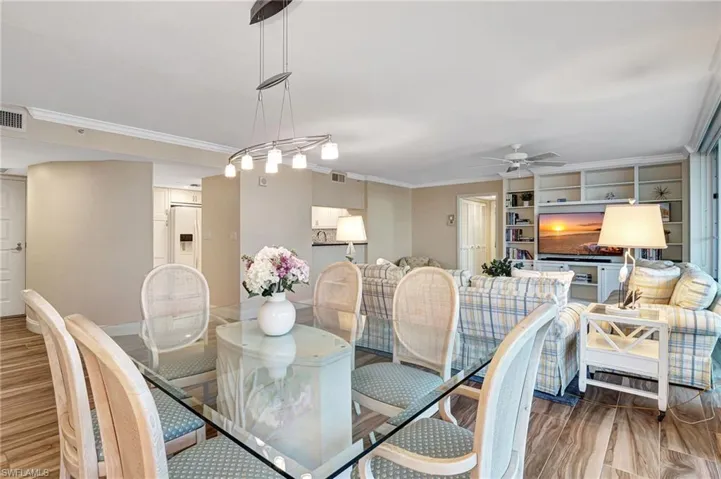 Dining room open to living room with built-in bookcase