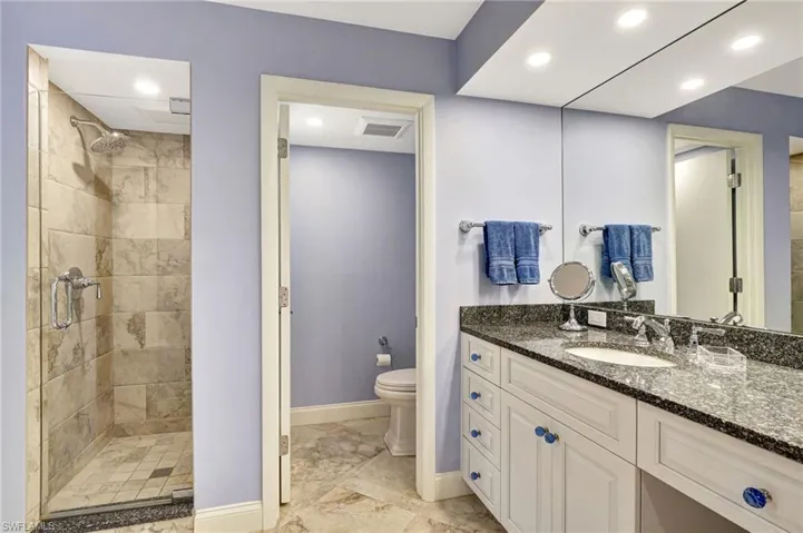 Bathroom with separate tile shower and commode room