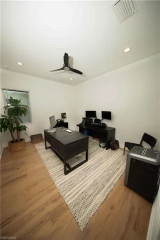 Bedroom used as an office featuring light hardwood / wood-style floors