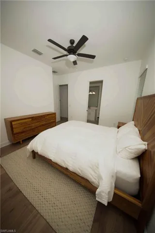 Bedroom featuring ceiling fan and dark hardwood / wood-style floors