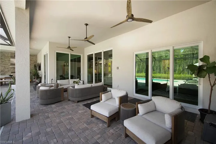 View of patio with outdoor lounge area and ceiling fan