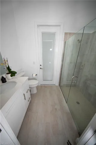 Bathroom with crown molding and a tile shower includes door to pool area