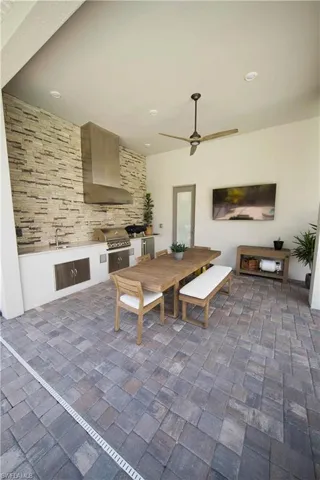 Home office with ceiling fan and wood-type flooring