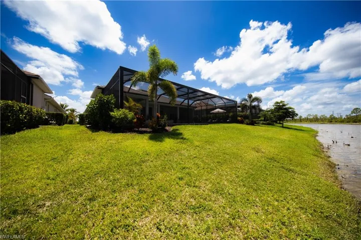 View of backyard facing pool area with canal