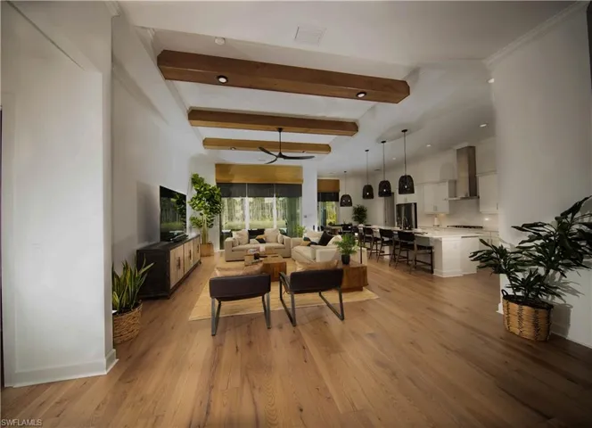Living room/ Great room featuring beamed ceiling and light hardwood / wood-style floors