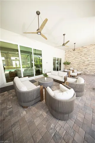 View of patio with outdoor lounge area and ceiling fan