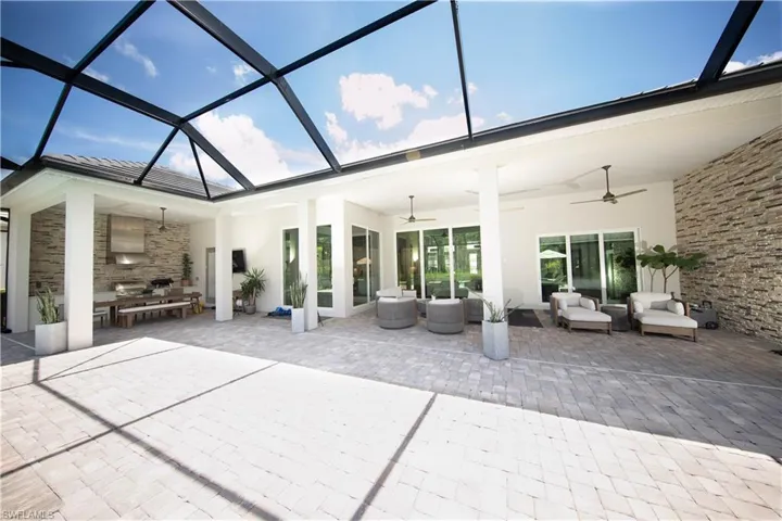 View of patio with ceiling fan and an outdoor living space