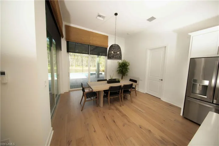 Dining room with light hardwood / wood-style flooring
