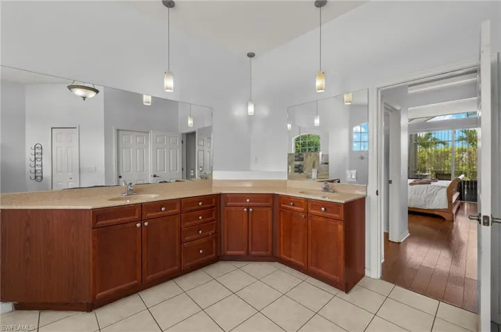 Kitchen with hanging light fixtures, sink, and light hardwood / wood-style flooring