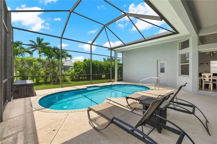View of swimming pool with a lanai and a patio area