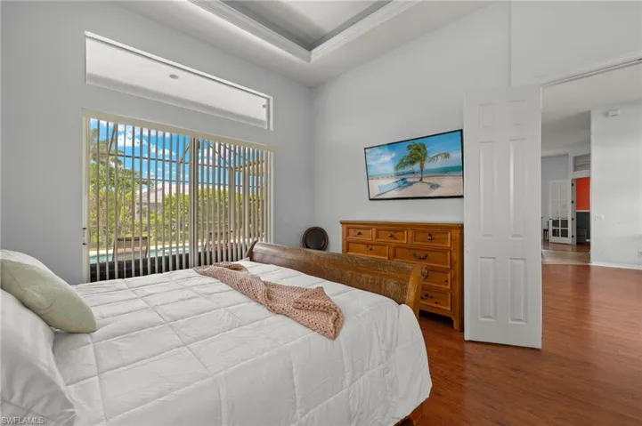 Bedroom with wood-type flooring and a high ceiling