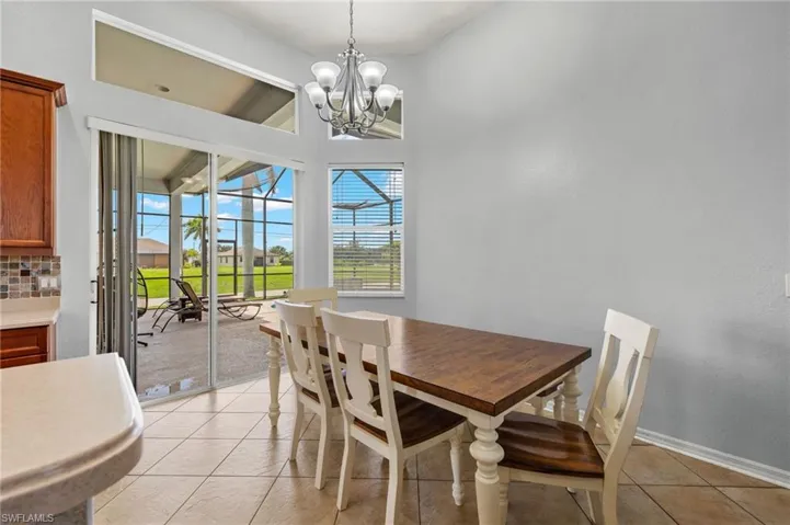 Tiled dining area with a chandelier