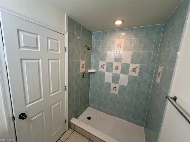 Bathroom featuring a stall shower and tile patterned floors