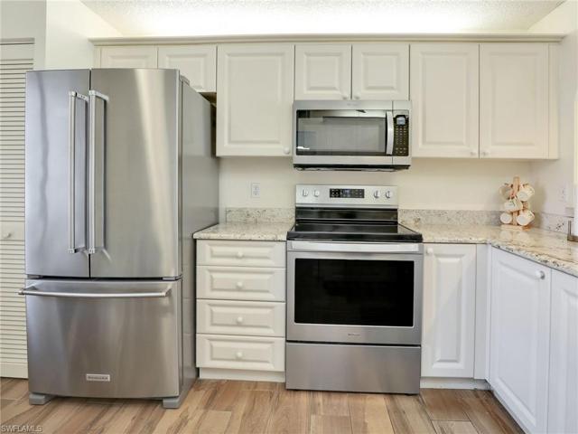 Stainless Steel KitchenAid Refrigerator, Whirlpool Range & Whirlpool Microwave