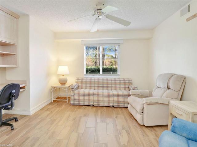 Den With Upgraded Wood Look Plank Tile Flooring & View Of The Lake
