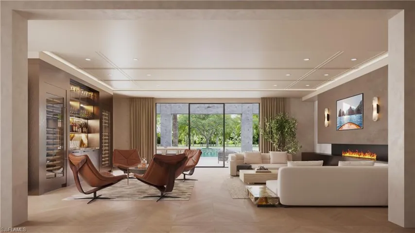 Great room featuring imported custom furnishings, double-length fireplace, Venetian plaster wall treatment, and backlit built-in bar w/stone counter and full height backsplash