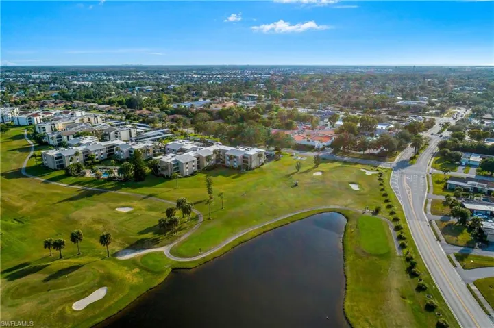 View of property location with a local golf course and a large body of water