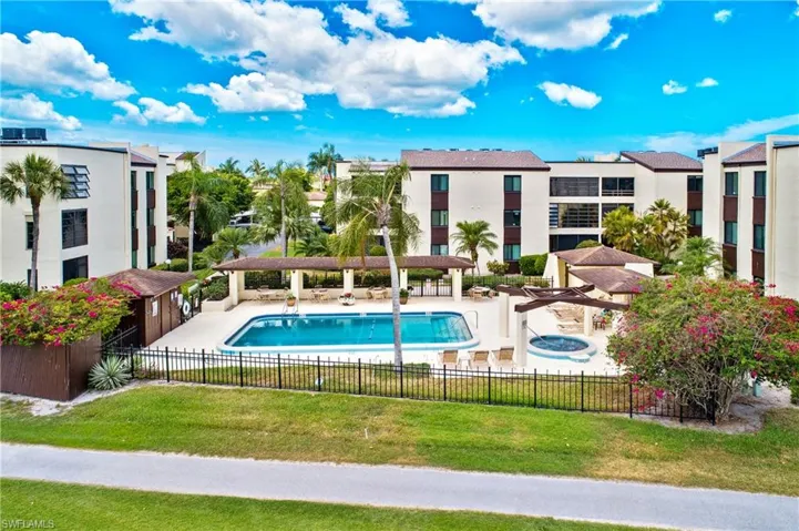 Community pool featuring a patio, a hot tub, and a pergola