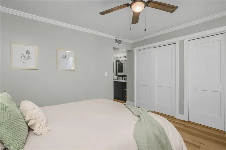 Bedroom featuring ornamental molding, large closet, ceiling fan, and Luxury Vinyl Wide plan floors